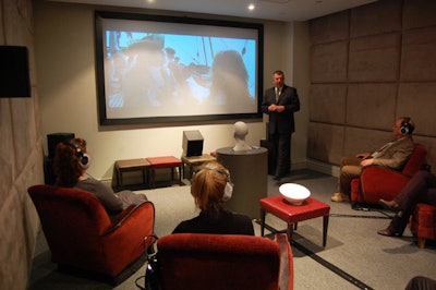 Dr. Tom Powers invited small groups of guests to try out the company's newest hearing instruments during technical demonstrations in the Spoke Club's screening room.