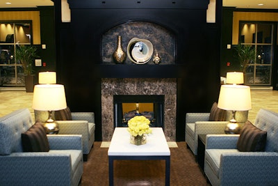 A seating area in the hotel's lobby features a fireplace and oversize chairs.