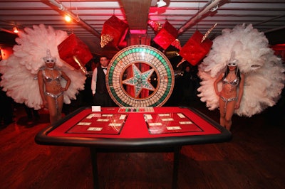A large money wheel flanked by showgirls sat at the entrance to the event.