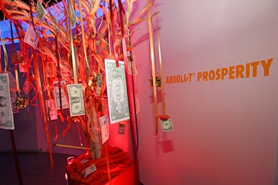 A money tree, meant to represent prosperity, featured orange ribbons strung with real and fake dollar bills.