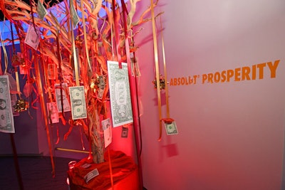 A money tree, meant to represent prosperity, featured orange ribbons strung with real and fake dollar bills.