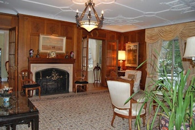 The formal living room opens onto a canopied terrace.