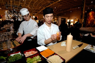 Servers from Edo Restaurant & Catering prepared sushi for attendees.