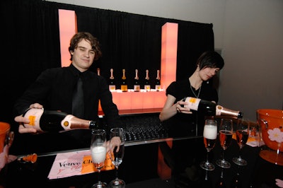 Servers offered glasses of Veuve Clicquot at a bar in the media lounge.