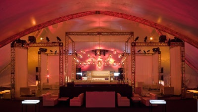 A four-sided truss bar served as the centerpiece of the tent with each corner flanked by a double-sided projection screen displaying basketball, football, and soccer game footage throughout the evening.