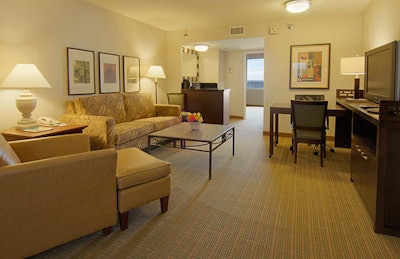 Each suite's living room is furnished with a large desk area, ergonomic chair, 37-inch flat-screen TV and upgraded high-speed Internet system.