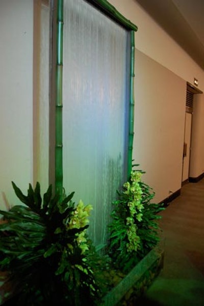 A water wall stood beside a buffet table that channeled the ocean with silky blue linens, shrimp, and oysters.