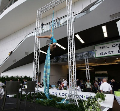 A silk aerialist from Circus Sarasota performed at the indoor On Location bungalow on Sunday afternoon.