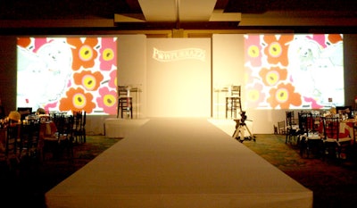 Gobos of the Pawpurrazzi's invitation, designed by Seraph, were projected onto either side of the runway.