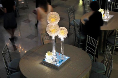 Mirrored boxes, silver linens, and crystal globes accented tables set up throughout the building.