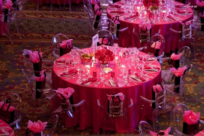 Silver vases filled with bright pink roses topped tables.