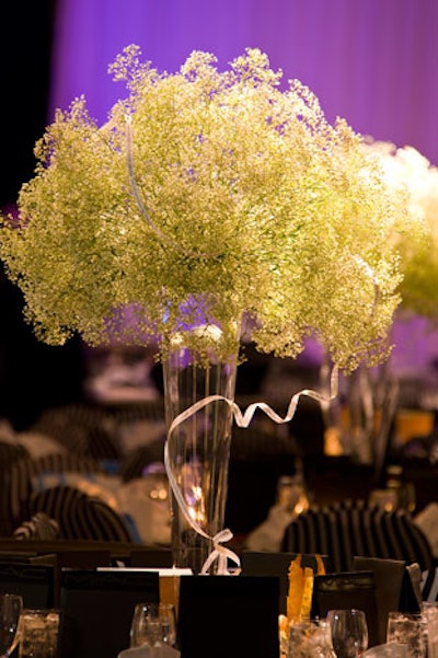 Tall glass vases filled with baby's breath served as centrepieces.