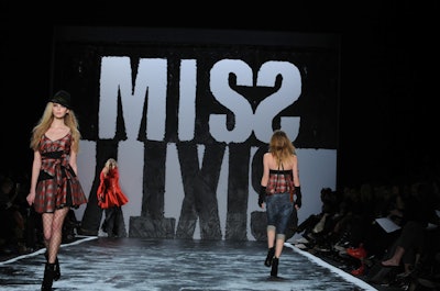 Miss Sixty brought in Jonathon Beck to create the set on Sunday night. Inside the tents, Beck adopted a graphic look with a black-and-white backdrop and a textured runway. Miss Sixty also partnered with Totes to create custom umbrellas as gifts for each attendee.