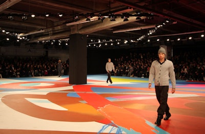 After years of production-heavy shows, Y-3 opted for a more subdued look at Pier 40 this season. Painted floorboards marked the runway of a Sunday-evening show for the Yohji Yamamoto line, and guests sat in bleachers.