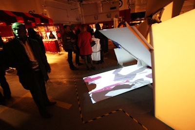 The installation from Eteam mixed drywall sheets with some of the McQ clothing and a mixed-media projection.