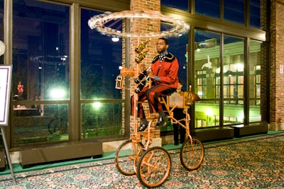 During the cocktail reception, a performer from Redmoon Theater pedaled the company's Wine Bike—which features an umbrella of spinning glasses—through the crowd.