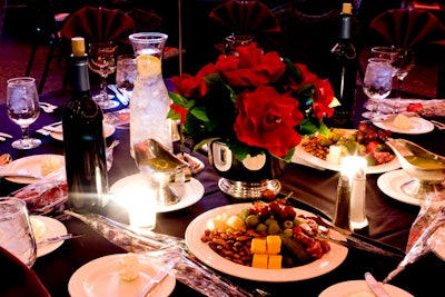 Red roses and plates of cheese, nuts, and fruit decorated each table.