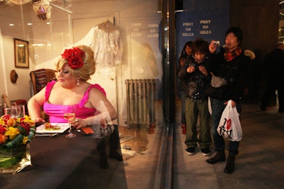 As was the goal of the publicity stunt, the diners caused curious passersby to stop and photograph the scene in the store window.