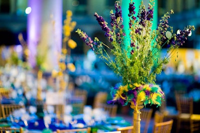 Enchanted Florist created centerpieces with dyed feathers at the base.