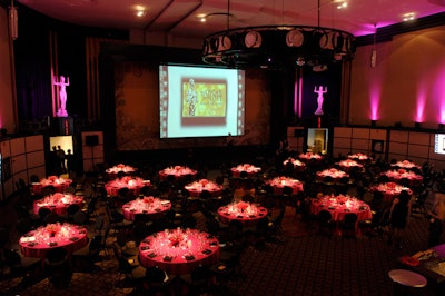 Pink lighting washed over the dining room, where guests watched the Oscar broadcast on three large screens.