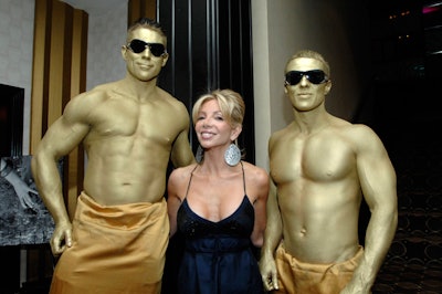 Canadian actress and comedian Carla Collins—who hosted the event—posed with two models dressed (barely) as Oscar statues prior to the cocktail reception.