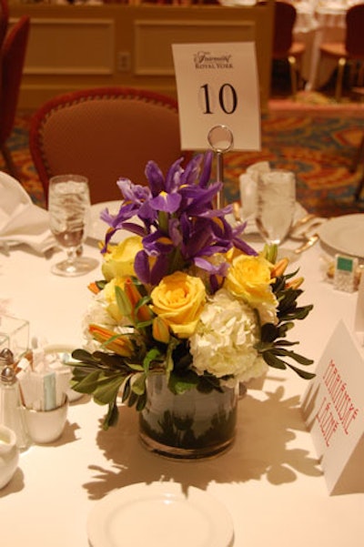 Centerpieces created by Paris Florist topped tables throughout the room.