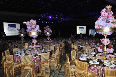 The royal-themed ball employed a purple and gold color scheme throughout including its elaborate tablescapes.
