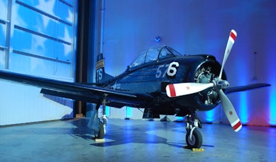 A vintage military plane was set up in a corner of the hangar.