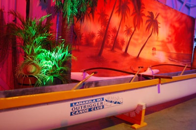 Polynesian Proud Productions used canoes, foliage, and sunset backdrops to create the island-themed side of the hangar.