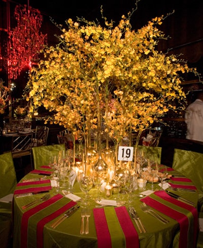 Sebastian Li grouped long-necked golden vases filled with sprays of yellow orchids.