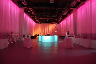 Organizers wrapped the Artifacts Room, the site of the cocktail reception and silent auction, in white draping, and washed the room in pink lighting.