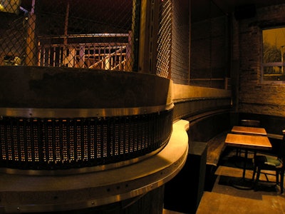 In the front room, a cage surrounds the DJ booth.