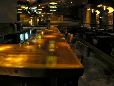 A former bowling lane forms a bar top in the front room.
