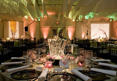 Green linens, black serving wear, and centerpieces incorporating white and pink blooms and jewel-shaped ice sculpture decorated tables.