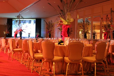 Large screens positioned at the end of the ballroom showcased the evening's speakers and live-auction items.