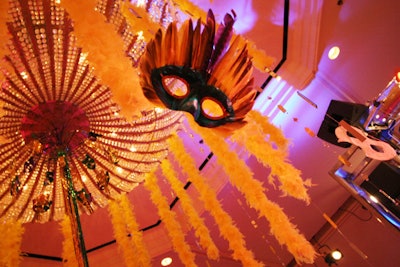 Boas, streamers, and masks hung from the ballroom's crystal chandeliers.