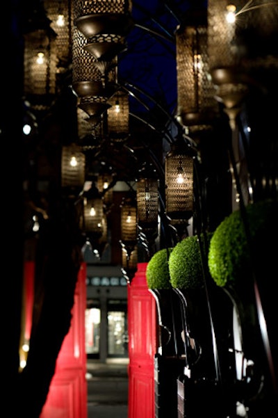 The narrow laneway leading to the entrance is lined with oversize mirrors and hanging lanterns.