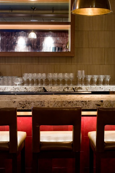The lounge features a granite-top bar with red leather accents.