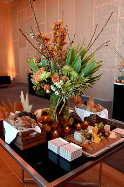Cheese platters and bread baskets surrounded a floral arrangement from Foiri Floral Designs on a table in the centre of the room.