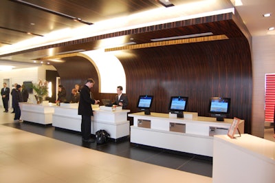 The Hirschberg Design Group used African Makassar wood to create a curved backdrop for the reception desk in the Hyatt Regency's lobby.