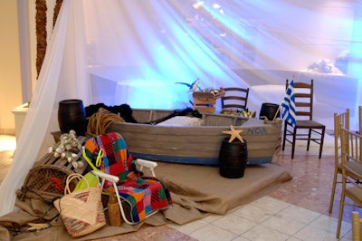 Event organizers used a fishing boat and beach chair to create a Greek-themed vignette.