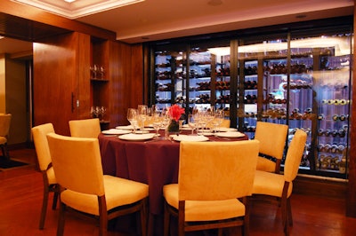 Overlooking the atrium through the restaurant's two-story wine wall is the Cuvée space, a private dining area.