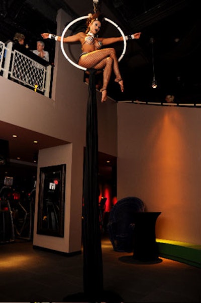An aerialist performed in the center of the bilevel space.
