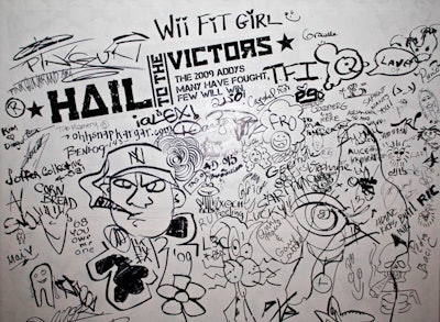 Guests signed their name to the temporary wall branded with the night's theme, 'Hail to the Victors.'