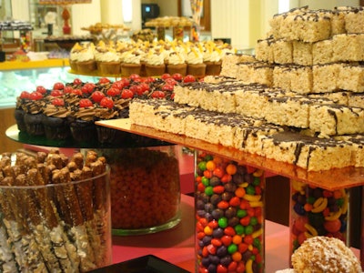 Chocolate-drizzled Rice Krispies treats, fudge brownies, mini cupcakes, and an assortment of candy were served on the cosmetics counters inside Saks Fifth Avenue.