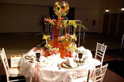 White linens and colorful vases fill Simply Elegant Florist and Event Co.'s Tablescapes display.