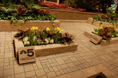 In one of the gardens, small paving stones showcase sponsor logos.