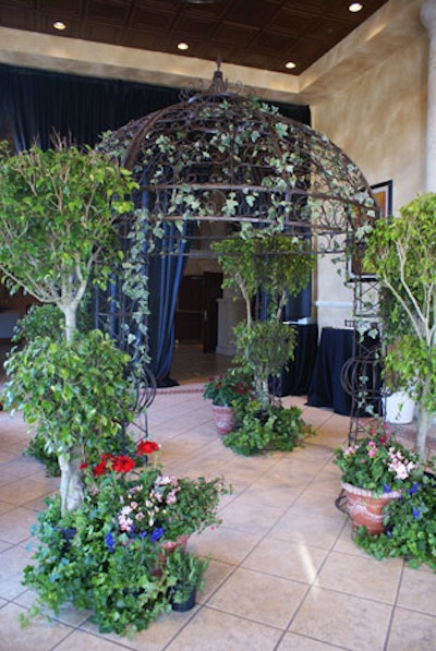 A trellis snaked with vines and surrounding plants added to the garden atmosphere.