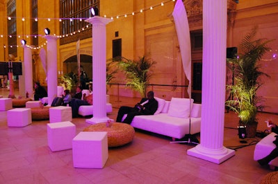 Palm trees, white couches, and string lights helped set the tropical scene.