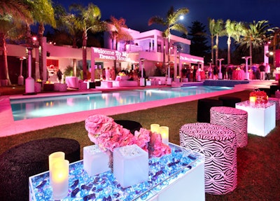 Ottomans lined the pool, and a gobo channeling Barbie's perspective read, 'Welcome to my dream house.'